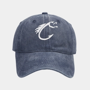 Detail view of a navy washed distressed baseball cap with a white fish hook graphic.
