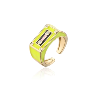 Detail view of gold-plated cassette tape ring with neon yellow enamel and white zircons