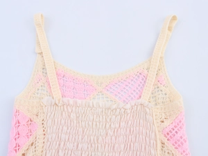 Detailed close-up of crochet knit texture and pleated fabric on summer camisole top