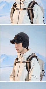 Detail of dark grey knit trapper hat with ear flaps and metallic FINN brand tag