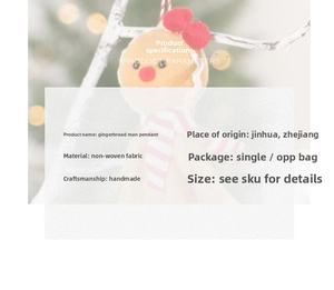 Detail of handmade gingerbread man ornament with red bow and striped scarf for Christmas tree
