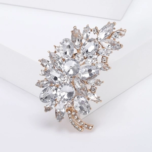 Macro shot of detailed floral alloy brooch with sparkling transparent rhinestones