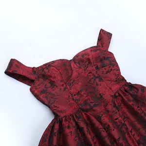 Close-up of burgundy floral jacquard fabric with off-shoulder neckline and clear straps
