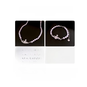 Size chart showing Saturn pendant necklace and bracelet dimensions with crystal details