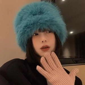 Stylish blue faux fur bucket hat and pink knitted gloves for winter warmth protection