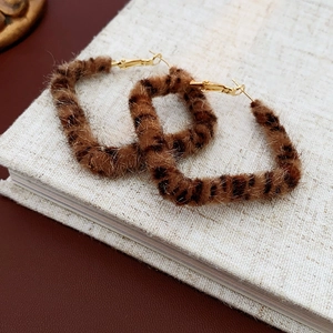 Detailed view of leopard print plush square hoop earrings with golden hooks