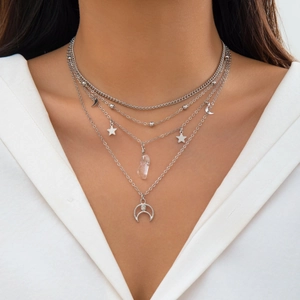 Silver multi-layer necklace with star moon pendants and crystal drop on model