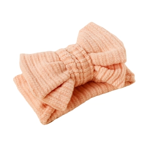 Pink elastic knitted baby headband featuring a large textured soft bow for infants