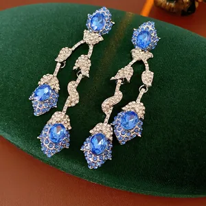 Vintage floral tassel earrings with deep blue oval stones and sparkling rhinestones