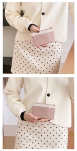 Close-up of pink and white leather card holder with zipper and multiple slots for women