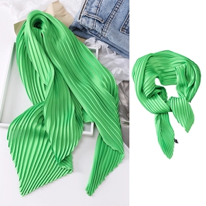 Vibrant green pleated silk scarf displayed as a stylish neckerchief and hair band accessory