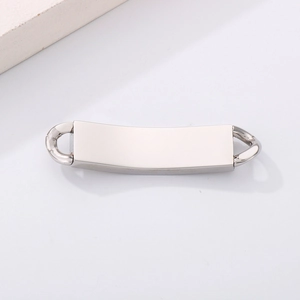 Close-up of polished silver stainless steel curved bar plate with link rings for DIY jewelry