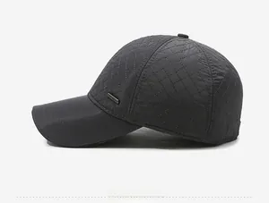 Detailed side view of dark grey quilted winter baseball cap with plush lining