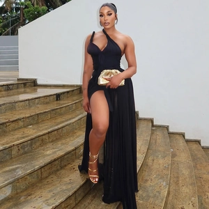 Detail of elegant black one-shoulder dress with high side slit and backless silhouette