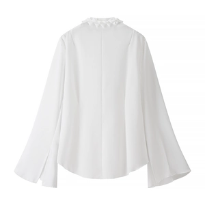 Detail view of the back of a white long sleeve blouse with elegant ruffled collar