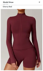 Close-up of cherry red seamless yoga jacket featuring stand collar and thumbhole cuffs
