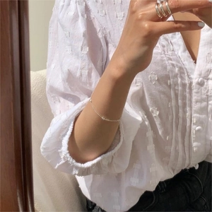 Minimalist S925 sterling silver olive bead bracelet and sleek ring set on model hand