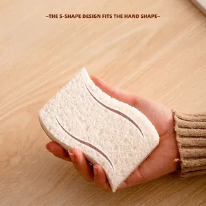 Hand holding white S-shape wood pulp cotton sponge on wooden table for kitchen cleaning