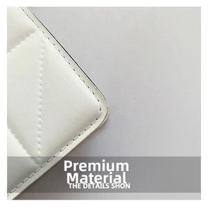 Close-up of white quilted leather texture and stitching detail on a trendy shoulder bag