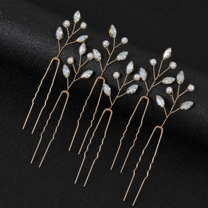 Detailed macro view of 6 gold bridal hair pins with white pearls and marquise stones