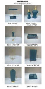 Macro view of dark green velvet and gold metal jewelry display stand collection