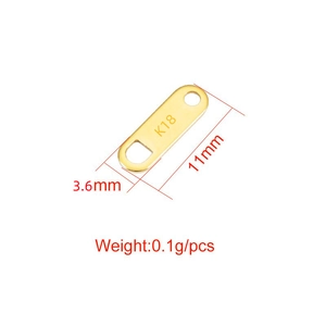 Macro view of 18K gold-plated stainless steel tag with 11mm dimensions and K18 engraving