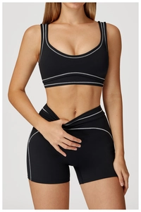 Detail of V-cross high waist and contrast stitching on black fitness shorts