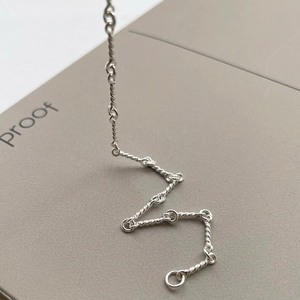 Minimalist S925 sterling silver twisted rope chain bracelet on a textured background