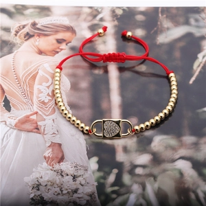 Adjustable red string bracelet with gold beads and a sparkling zircon heart lock charm