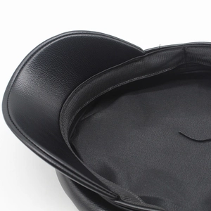Detailed close-up of the black PU leather newsboy hat lining and reinforced stitching