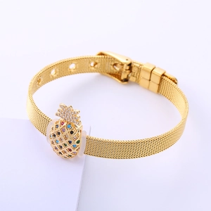 Detail of a golden mesh watch-strap bracelet with a colorful zircon pineapple charm