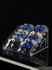Detailed macro view of 6-tier transparent acrylic sunglasses display stand on black surface