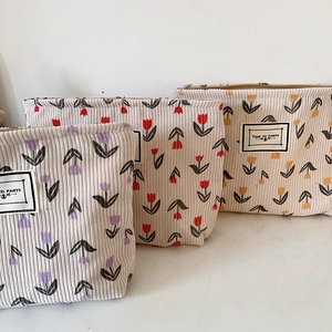 Three-piece floral corduroy cosmetic bag set with tulip patterns and zipper closure