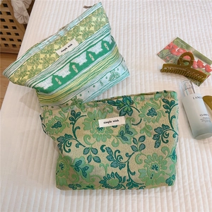 Macro detail of high-quality jacquard fabric and floral patterns on cosmetic bags