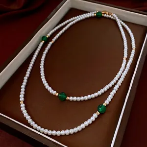 Double-layered pearl necklace with green agate beads and gold accents in retro style