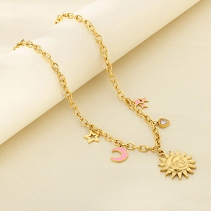 Close-up of 18K gold-plated chain featuring sun, moon, and star pendants with pearl details