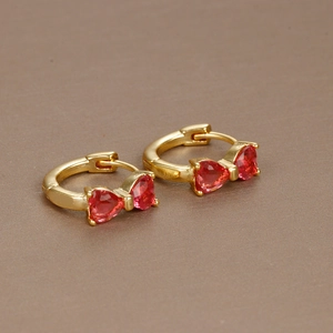 Exquisite 18K gold bow hoop earrings featuring vibrant red heart-shaped zircon stones