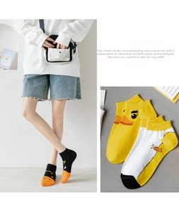Detail view of cartoon duck low-cut socks in black, yellow, and white cotton blend