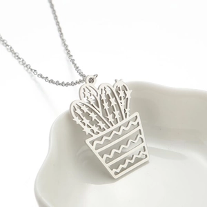 Detailed close-up of a silver cactus pendant necklace with an elegant hollow design