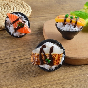 Detailed macro view of miniature salmon and tamago sushi models on a wooden tray