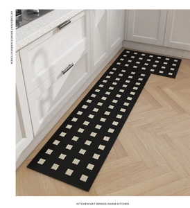 Detail view of two-piece black and white checkered kitchen mats on wood floor