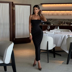 Elegant slim fit black midi dress with ruched details for women in a luxury restaurant