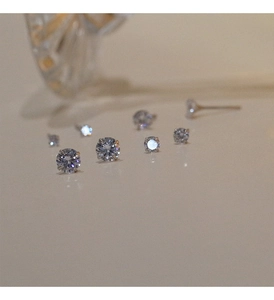 Macro shot of various sizes of silver prong-set round cubic zirconia stud earrings