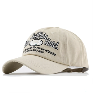 Detail of Dolphin Hotel embroidery on vintage washed beige cotton baseball cap