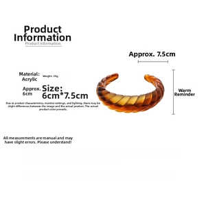 Macro detail of amber acrylic spiral bracelet showing 24g weight and 6cm x 7.5cm size