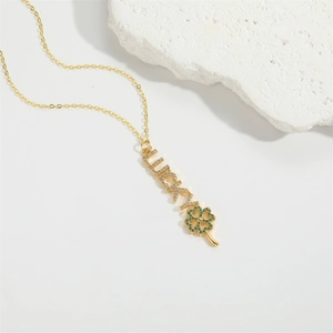 French vintage style gold necklace with LUCKY letters and green clover pendant on stone