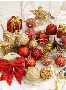 Detailed view of red and gold glitter Christmas balls and star ornaments set on snow