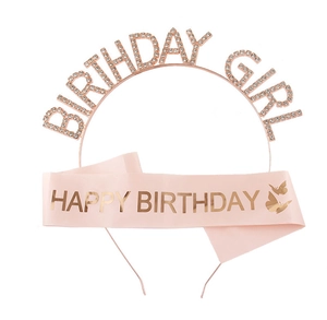 Detail of pink satin birthday sash with cutout lettering and rhinestone metal tiara