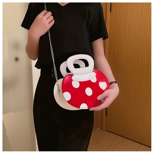 Creative red mushroom crossbody bag with white dots and golden chain on model