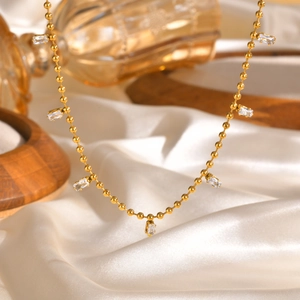 Golden stainless steel ball chain necklace featuring elegant white square zircon stones